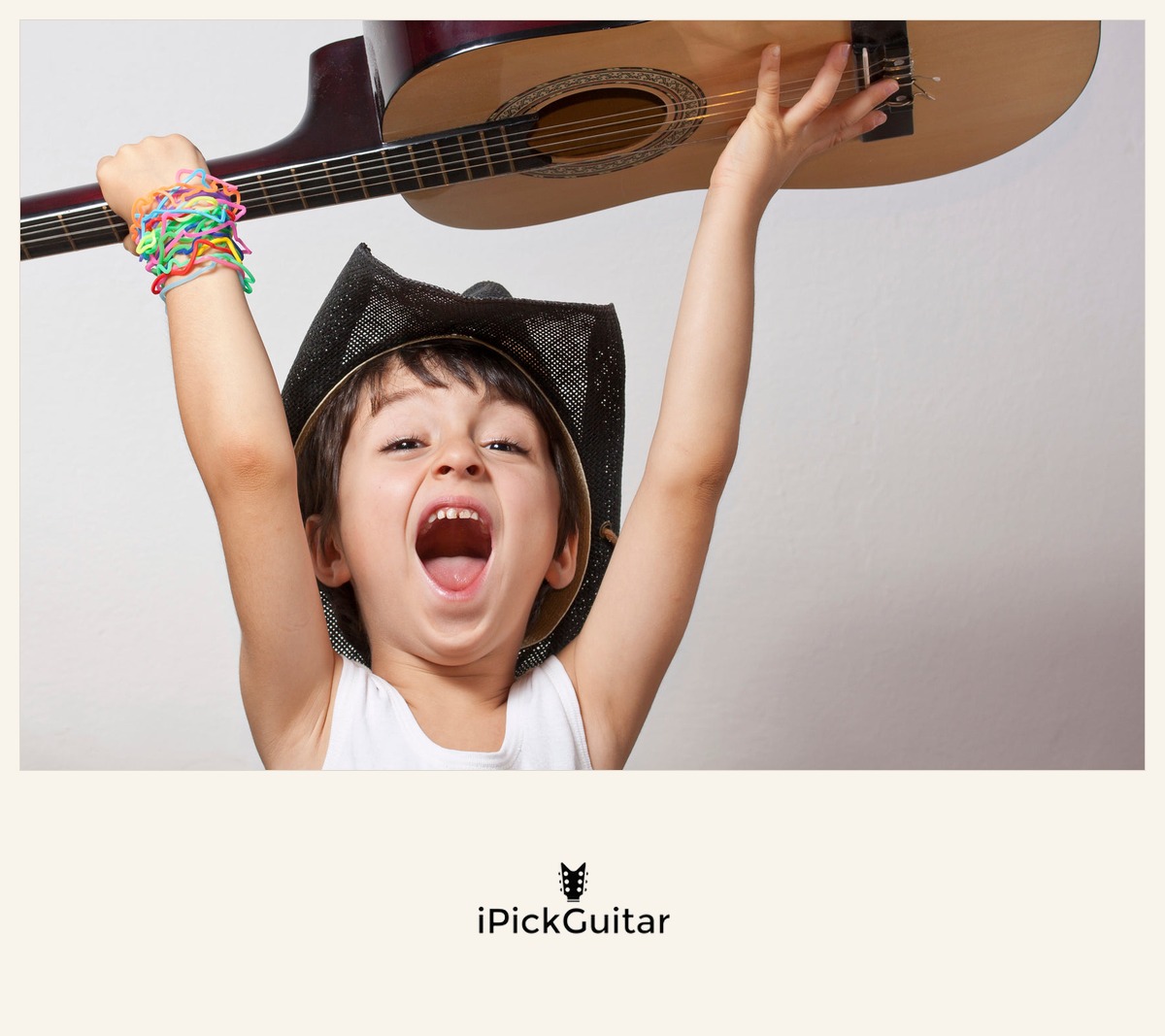 iPickGuitar — a smiling young student holding his classical guitar overhead